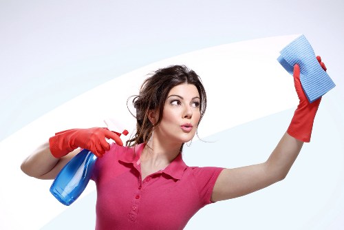 Removing debris from gutters to prevent overflow and water damage